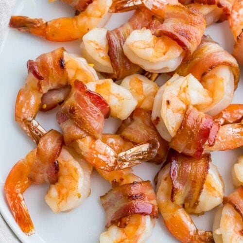 Bacon wrapped shrimp on a white plate