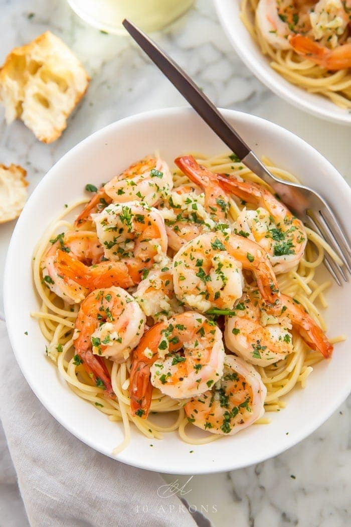 Garlic butter shrimp served with pasta in a white bowl