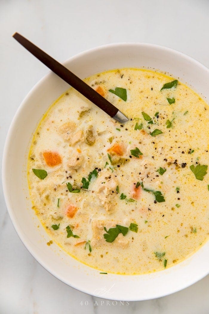 Chicken and rice soup garnished with fresh herbs