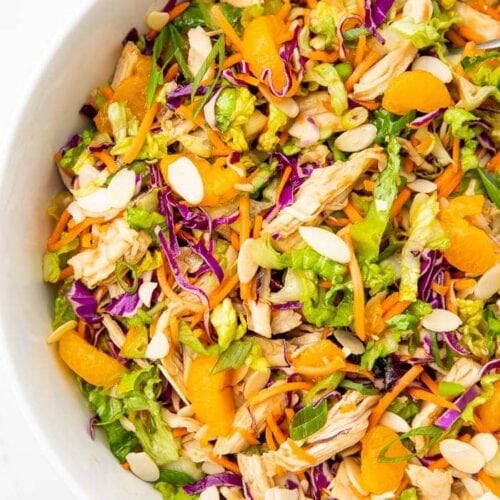 Overhead angle of part of a white bowl containing Chinese chicken salad