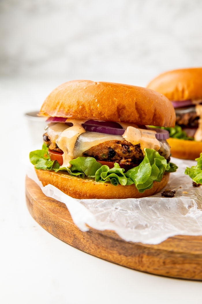 Two black bean burgers on a wooden board