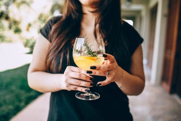 Woman holding a large cocktail