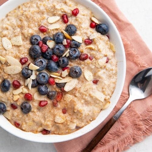 Bowl of steel cut oats with a pink napkin and spoon