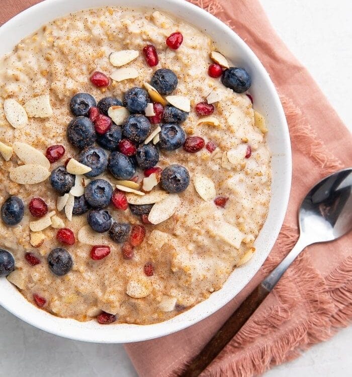 Bowl of steel cut oats with a pink napkin and spoon