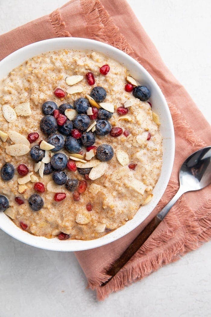 Bowl of steel cut oats with a pink napkin and spoon