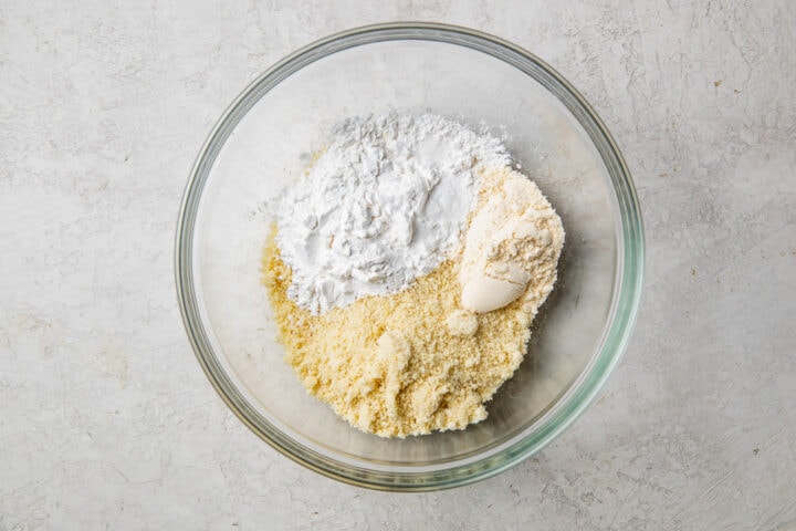 Dry ingredients for paleo pancakes in a glass mixing bowl.