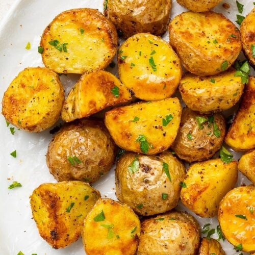 Roasted potatoes on a white platter