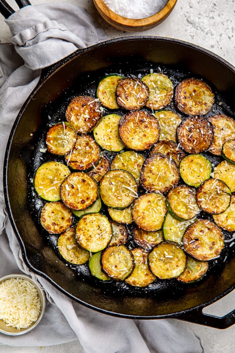 Crispy sauteed zucchini discs topped with finely shredded cheese.