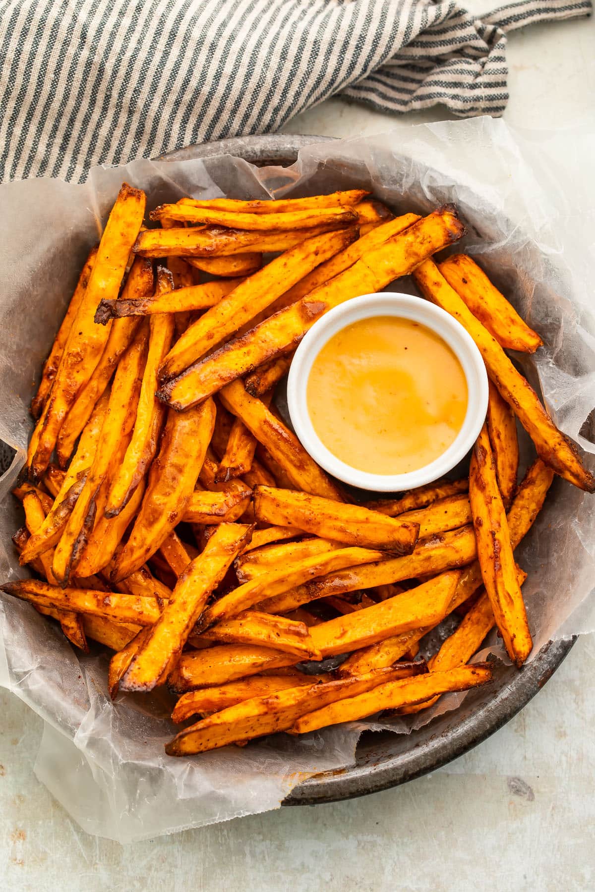 A bowl of homemade air fryer sweet potato fries on a table.