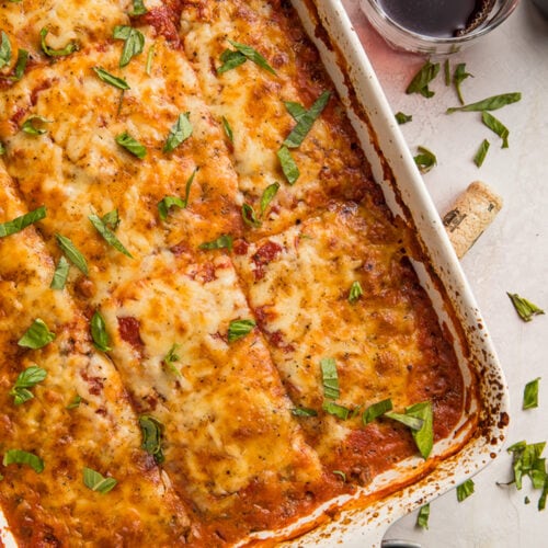 Overhead view of a casserole dish full of eggplant lasagna. cut into 12 large squares.