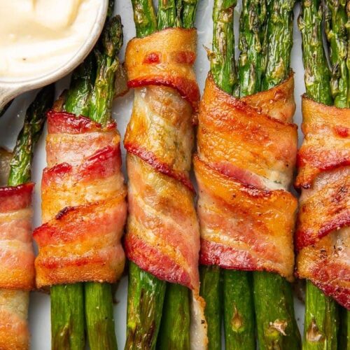 Bacon-wrapped asparagus stalks placed vertically in a row