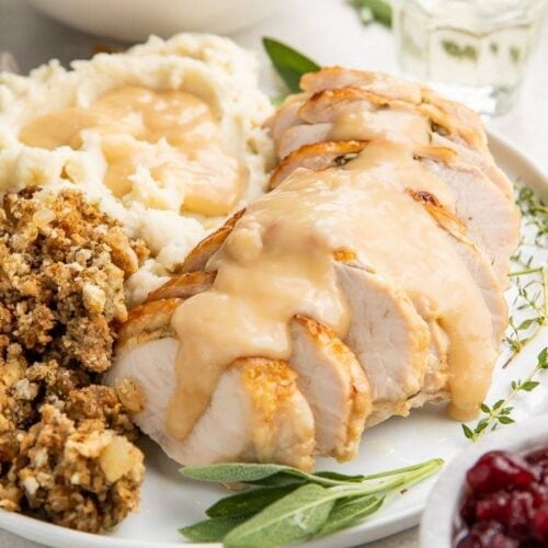 Instant Pot turkey breast slices covered with gravy on a plate