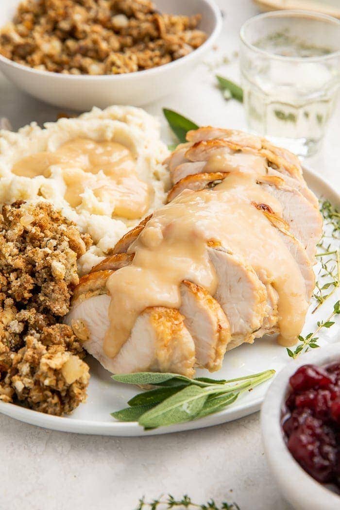 Instant Pot turkey breast slices covered with gravy on a plate