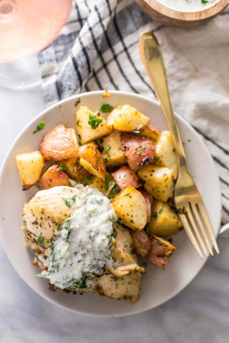 Overhead image of paleo greek chicken on white plate with fork.