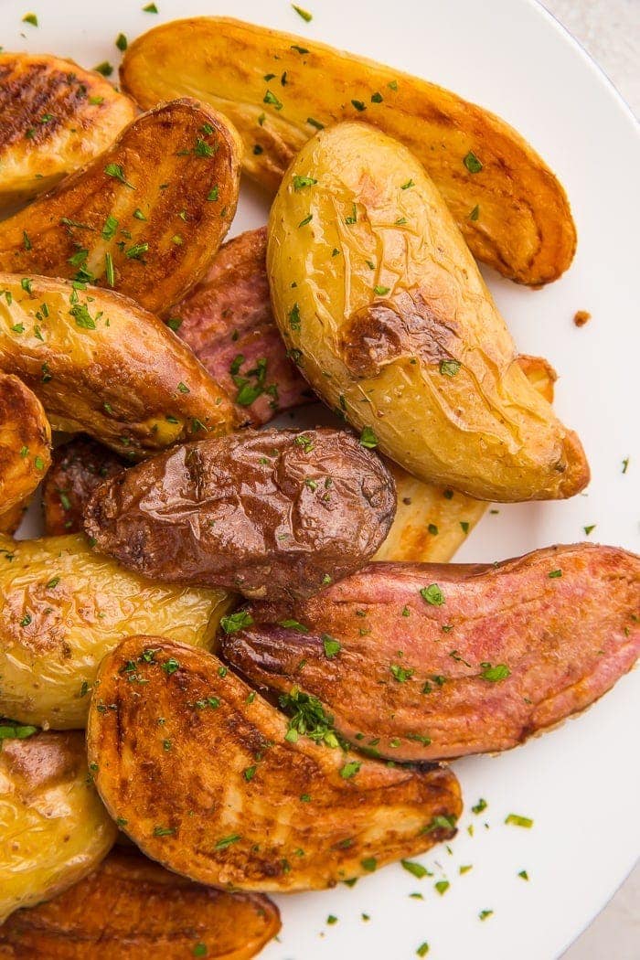 Overhead shot of fingerling potatoes on a white plate