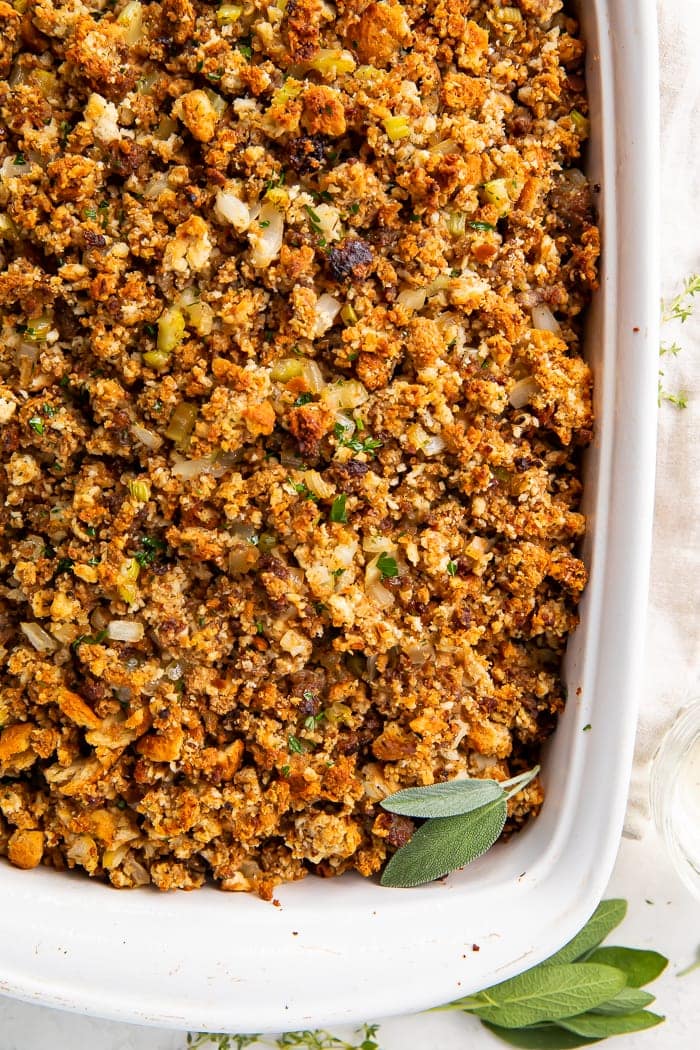 Close-up overhead shot of sausage stuffing in a white baking dish