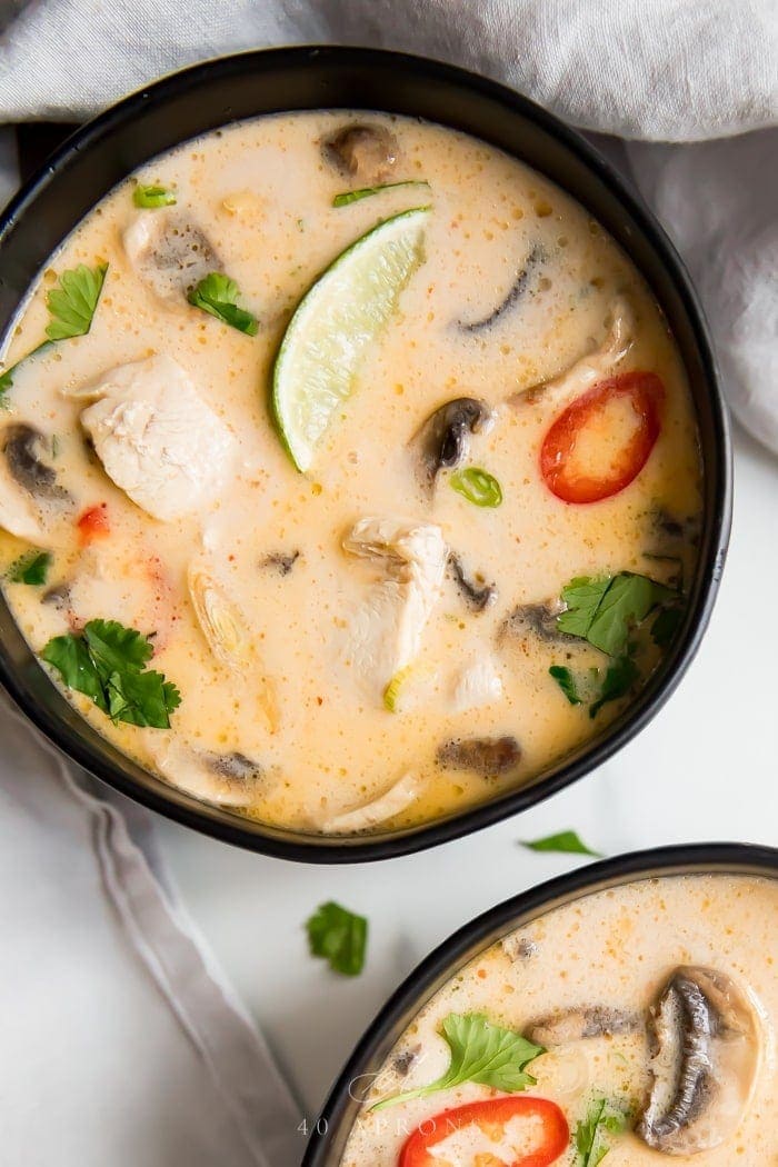 Black bowls with tom kha soup