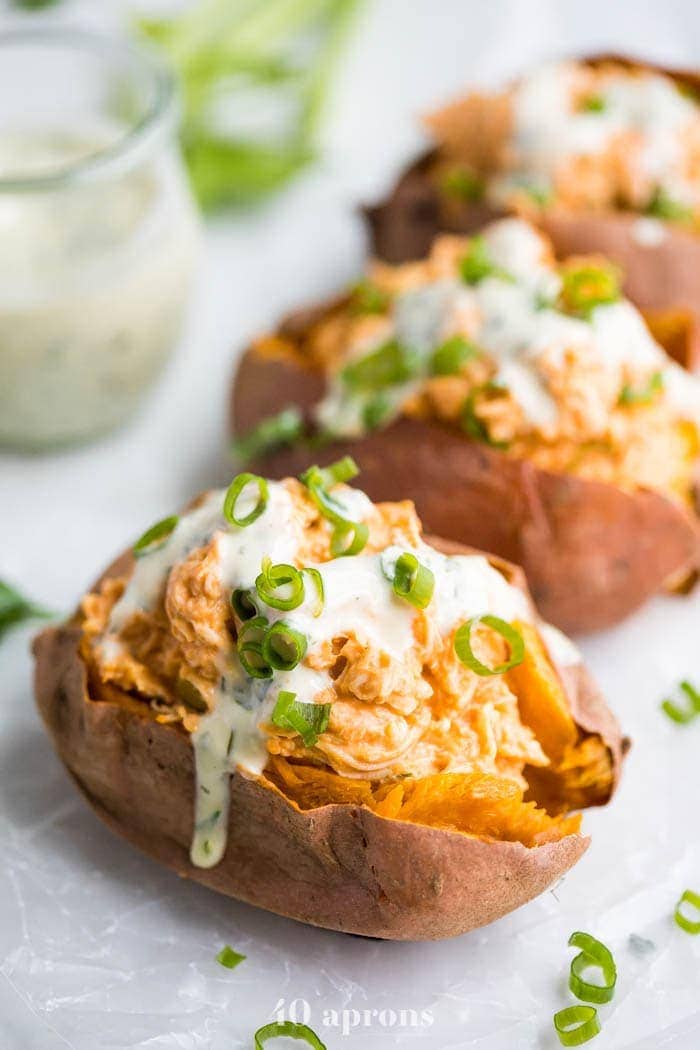 Sweet potatoes stuffed with whole30 buffalo chicken