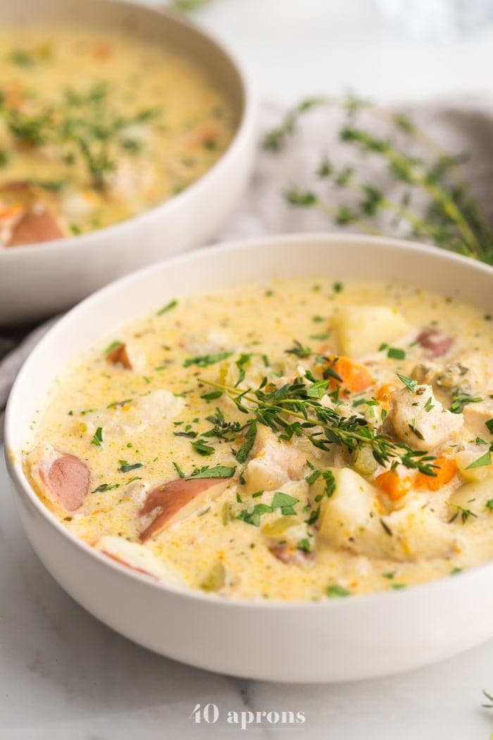 Pot pie soup in white serving bowls