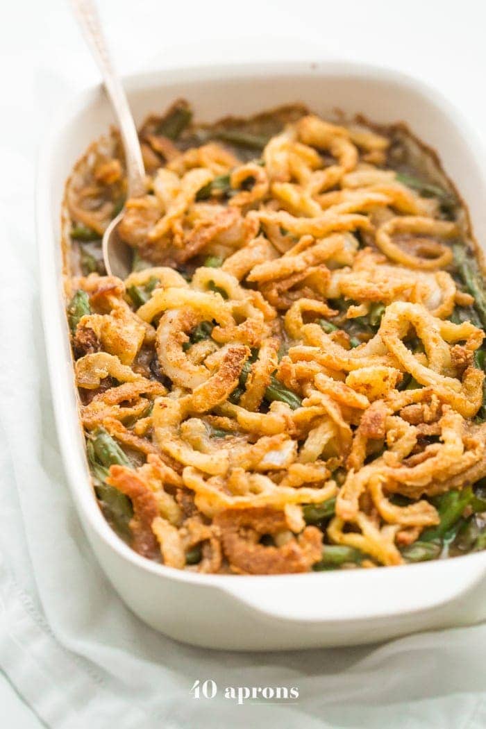 Whole30 green bean casserole in a white ceramic baking dish