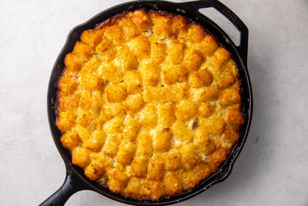 Baked tater tot breakfast casserole in a cast iron skillet