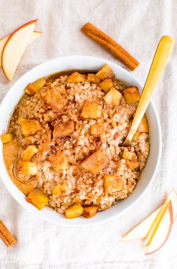 A white bowl holding vegetarian crockpot cinnamon apple oatmeal