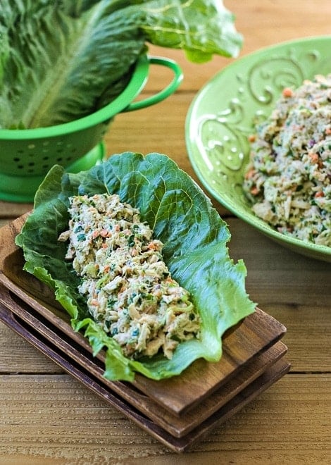 Tuna salad in a romaine lettuce leaf sitting on wooden trays