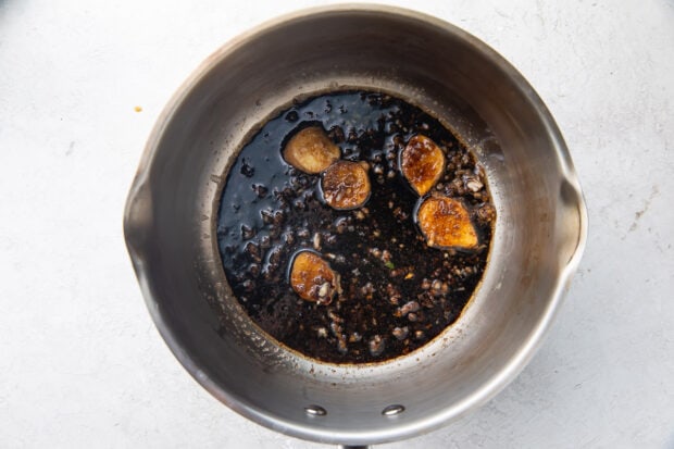 Garlic, ginger, oil, and soy sauce in a large silver pot