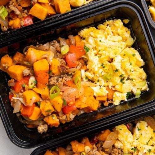 Reusable meal prep trays with sweet potato, scrambled eggs, and sausage for a whole30 breakfast