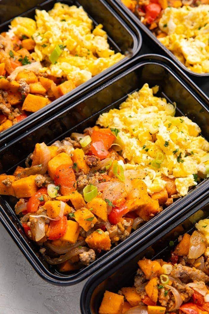 Reusable meal prep trays with sweet potato, scrambled eggs, and sausage for a whole30 breakfast