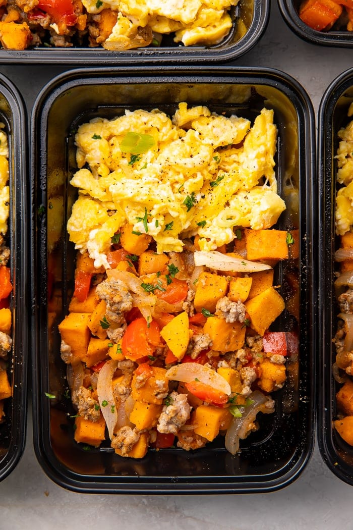 Reusable meal prep trays with sweet potato, scrambled eggs, and sausage for a whole30 breakfast