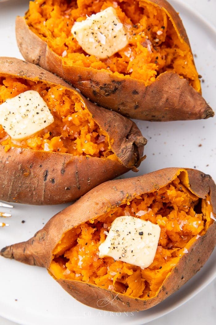 Three Instant Pot sweet potatoes with pats of butter