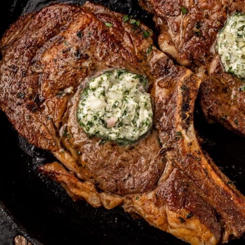 Top view of bone-in ribeye in cast iron skillet