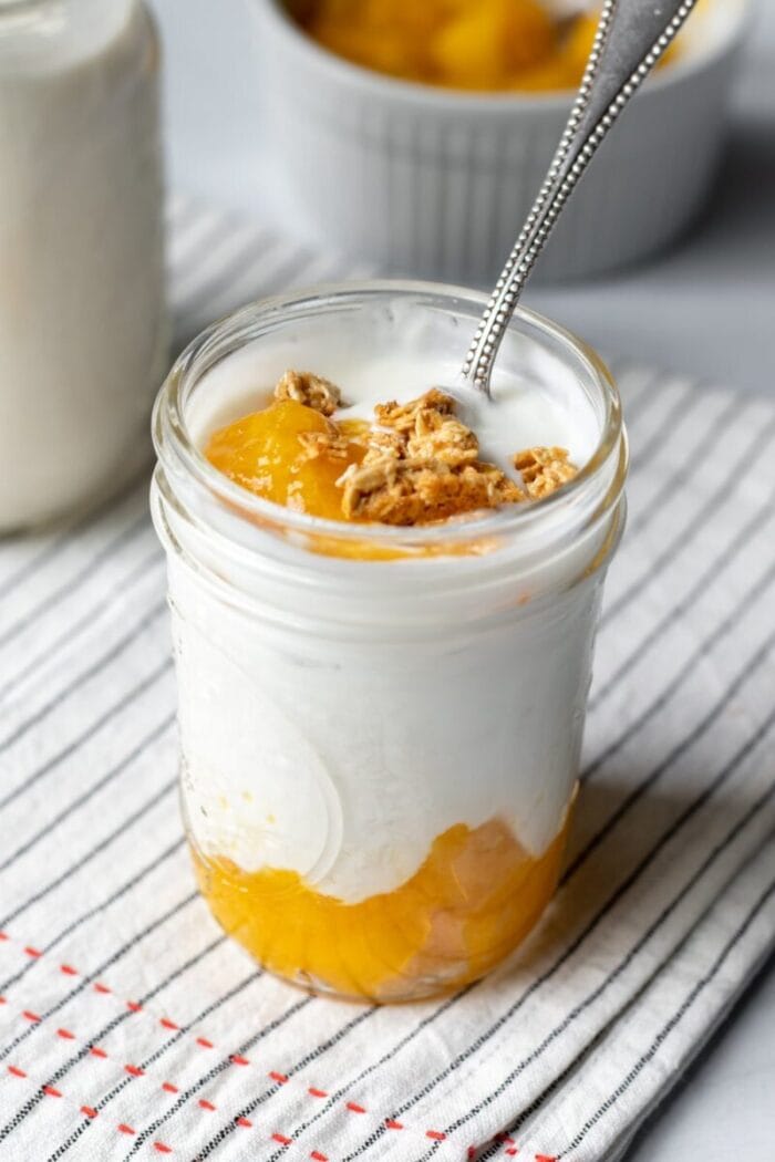 Glass mason jar of cashew yogurt and fruit