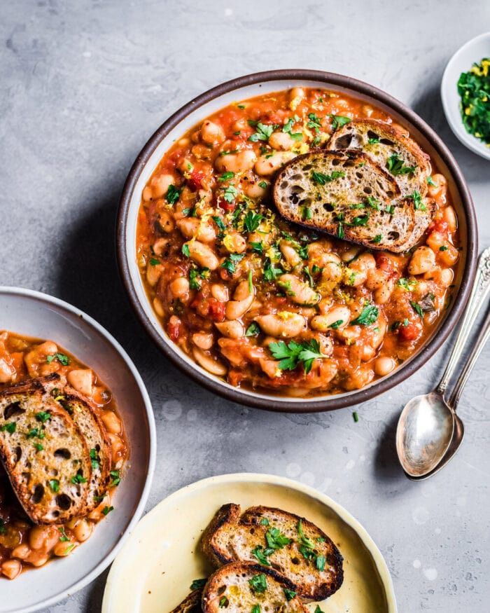 A bowl of vegan white bean chili on a light background