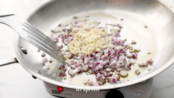 Onions and garlic sauteed in a large skillet