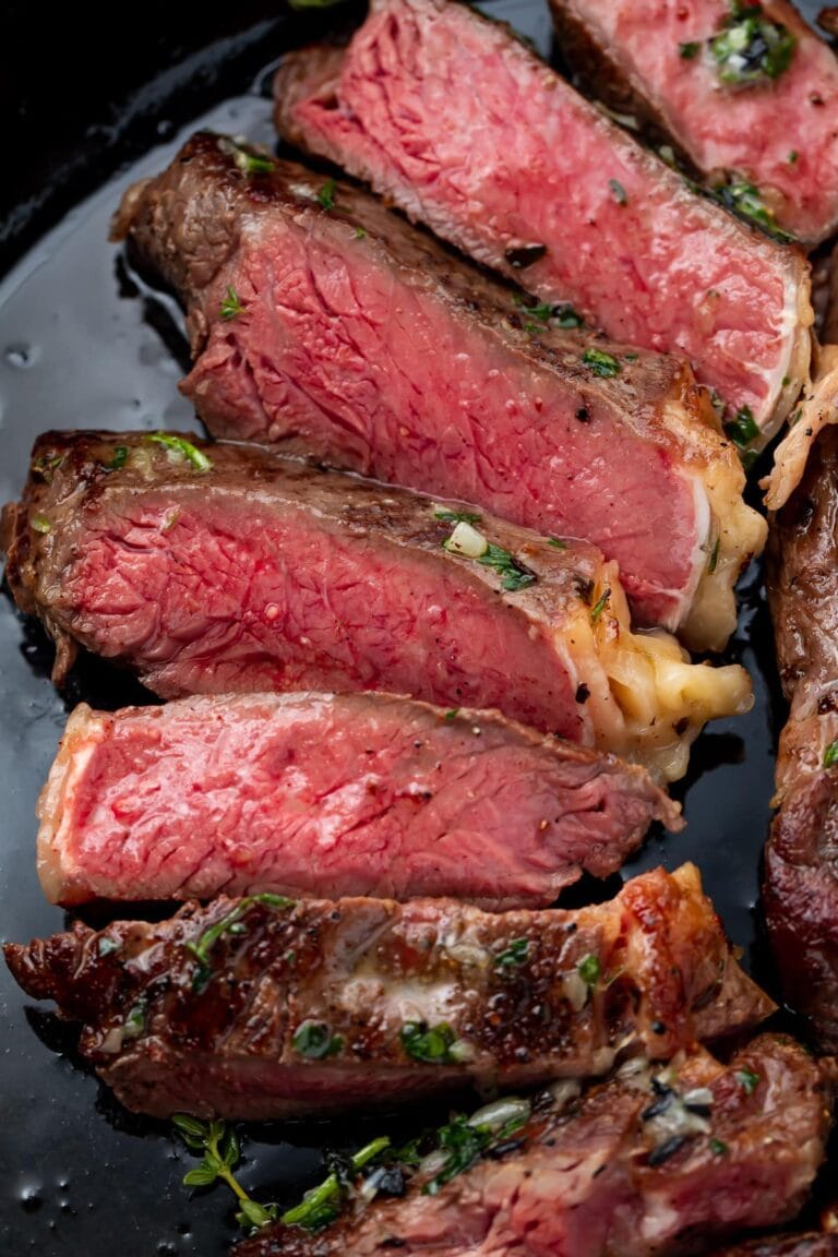 Red interior of a medium-rare cut sous vide ribeye arranged on a plate