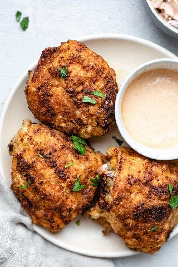 3 chipotle chicken thighs on a white plate