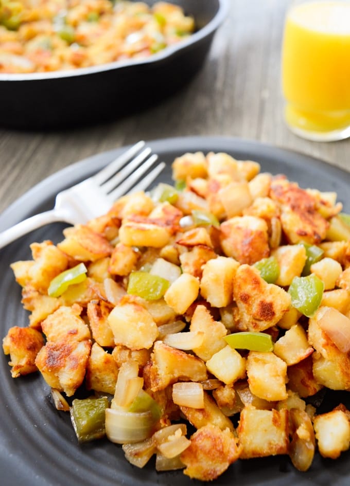 A grey plate holding instant pot breakfast potatoes with peppers