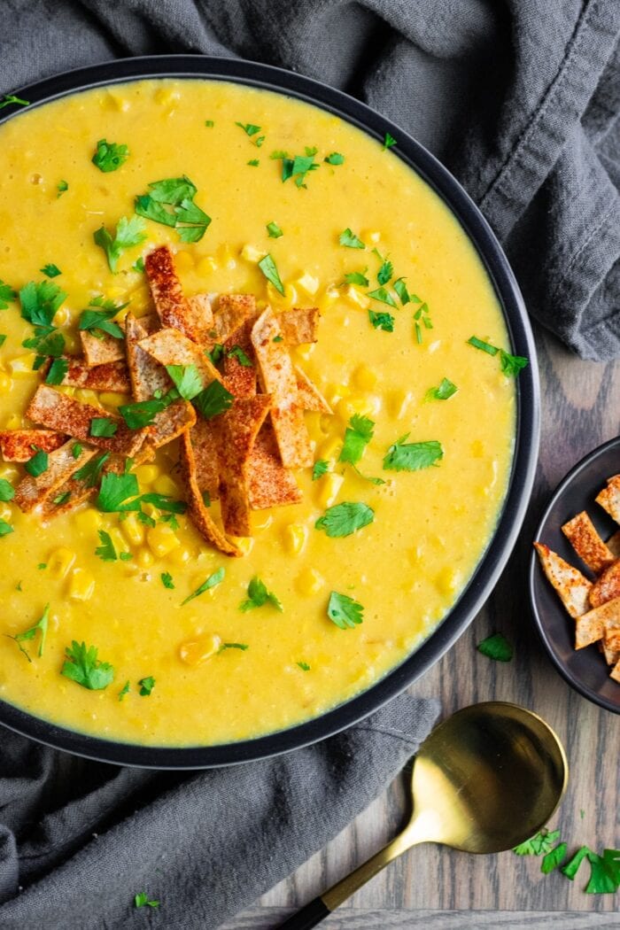 Yellow corn chowder in a black bowl