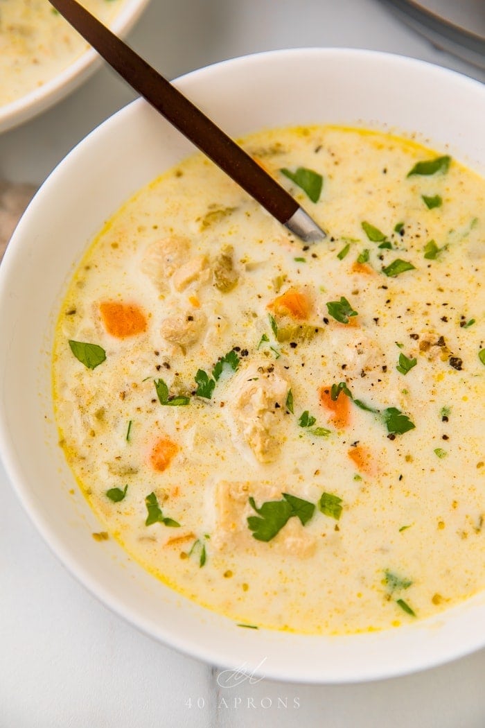 A white bowl of low carb chicken and cauliflower rice soup