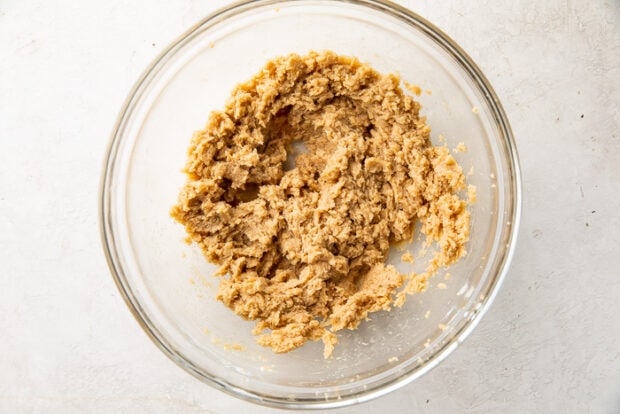 Beginnings of vegan chocolate chip cookie dough in a glass mixing bowl