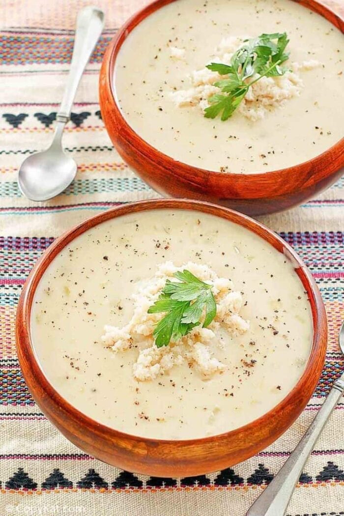 2 red bowls of bisque on a patterned background