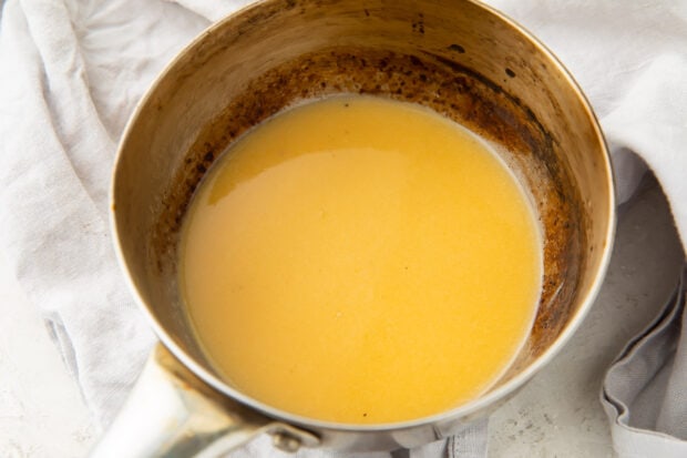 Lemon butter sauce in a silver bowl