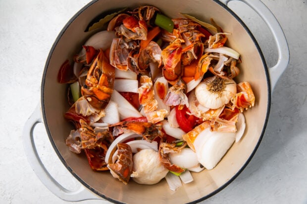 Lobster shells, onion, garlic, and vegetables in a large pot