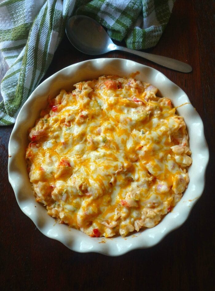 Cheesy crab casserole in a scallop-edge white casserole dish