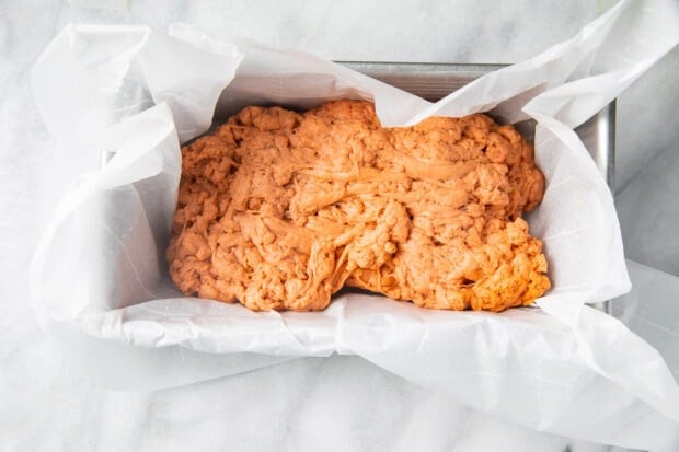 Homemade seitan in a loaf pan with parchment paper