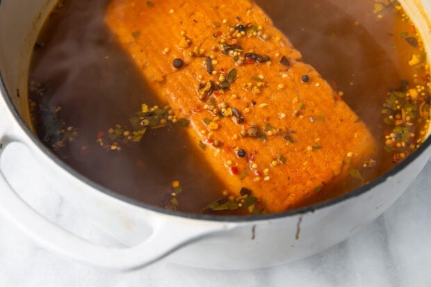 Seitan in a large pot of broth and seasoning