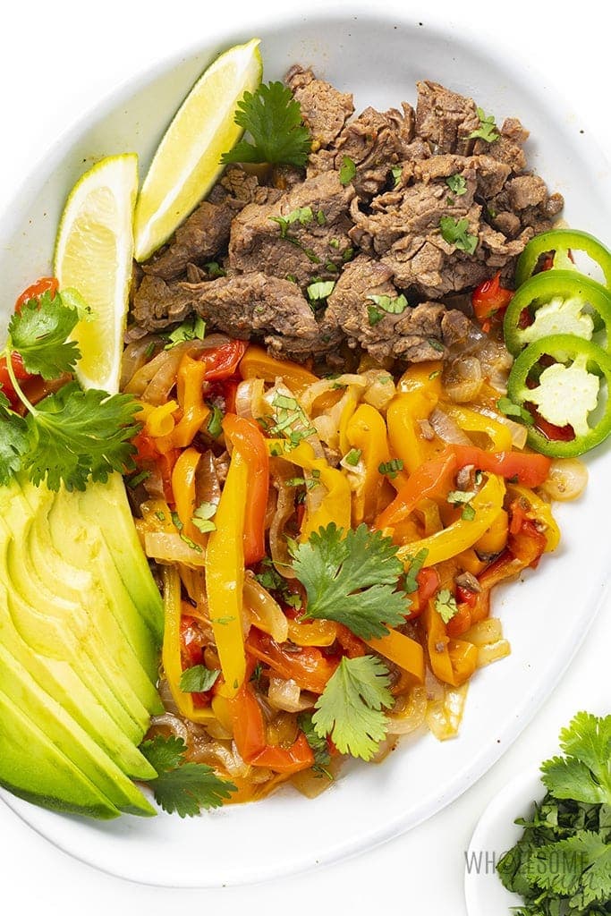 Instant pot steak fajita tray with steak, peppers, and avocado