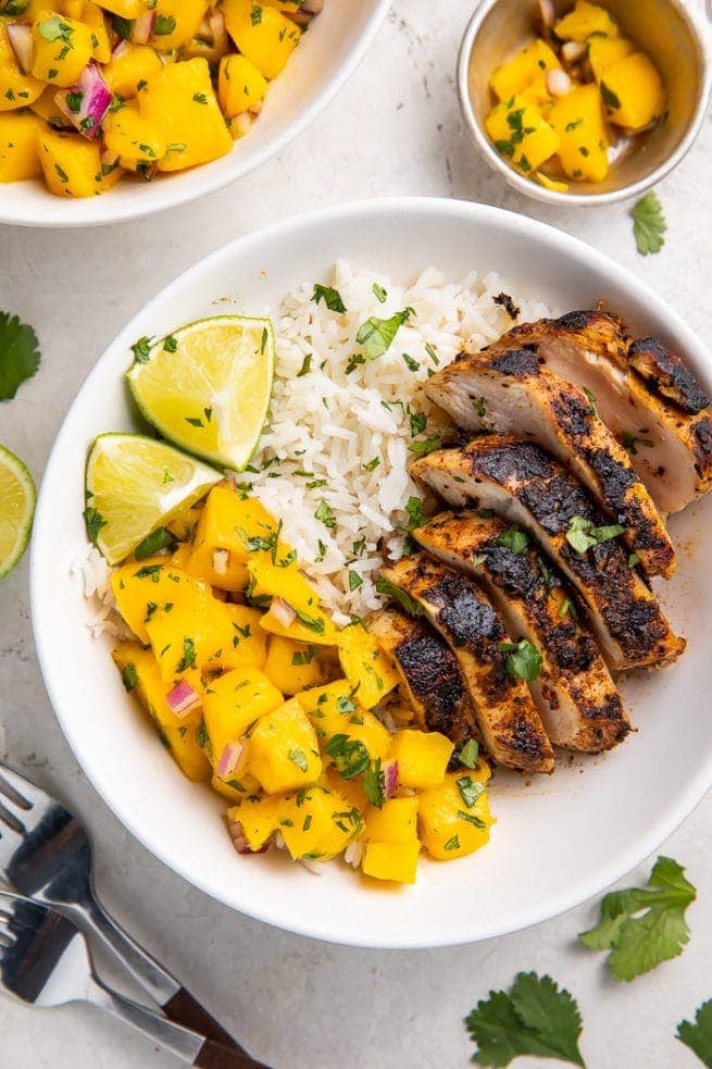 Jerk chicken bowl with coconut rice and mango